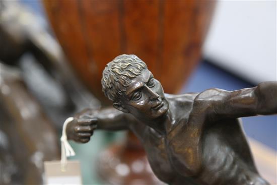 A bronze figure of a nude archer standing upon a rocky outcrop, 22in.
